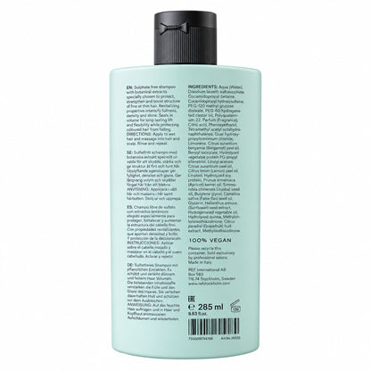 A 285 ml bottle of shampoo shown from the back, featuring a pale mint green body and a black ribbed cap, with detailed product text printed on the side.